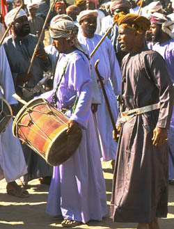 Omani musicians paying at a camel race