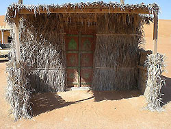 Vorplatz einer Palmzweighütte im Nomadic Desert Camp